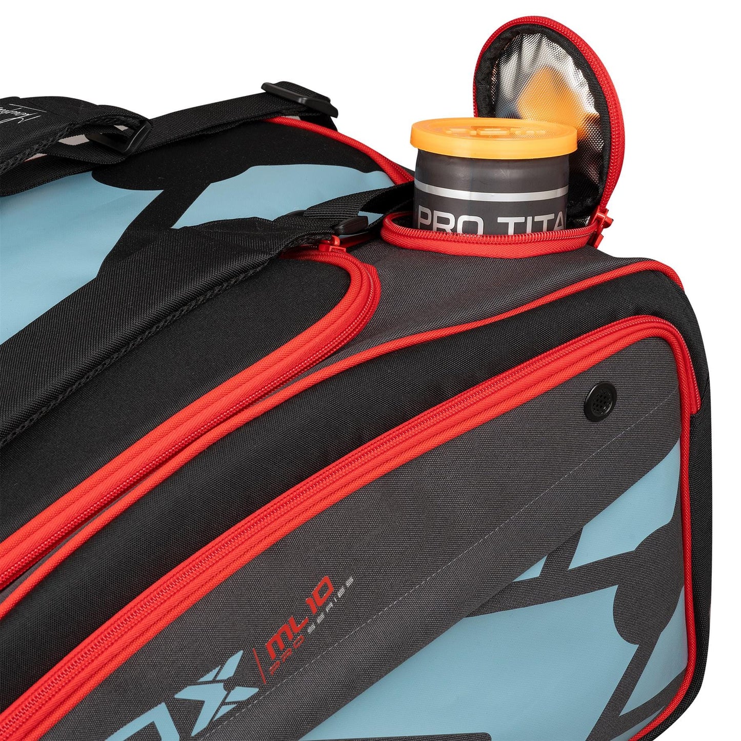 A close-up of a NOX ML10 Team Padel Racket Bag - Black / Clay with red zippers and a blue and black design. The open side pocket reveals an orange water bottle marked "PRO TITAN.