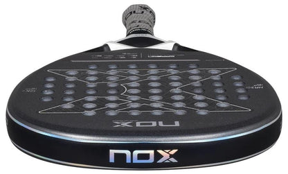 A close-up of the NOX Luxury Quantum 12K Carbon 2025 Padel Racket, showing its perforated black surface and NOX logo near the handle, crafted with 12K carbon fiber for superior performance.