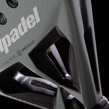 Close-up of the Bullpadel HACK 04 2026 padel racket, featuring angular cut-out details and dynamic power, with the white "padel" logo and "THE PADEL SPECIALIST" text from Bullpadel visible on its surface.