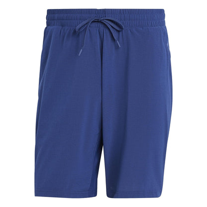 The ADIDAS Ergo Men's Padel Shorts in navy feature an elastic waistband and drawstring, crafted from recycled materials. The textured fabric ensures comfort without visible logos or patterns, perfect for eco-conscious individuals seeking lightweight shorts.