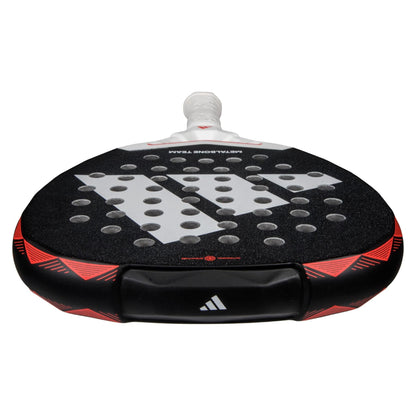 Close-up of the adidas Metalbone Team 3.4 padel racket, featuring a white handle, bold adidas logo, circular holes, and red accents—ideal for players wanting aggressive performance on the court.