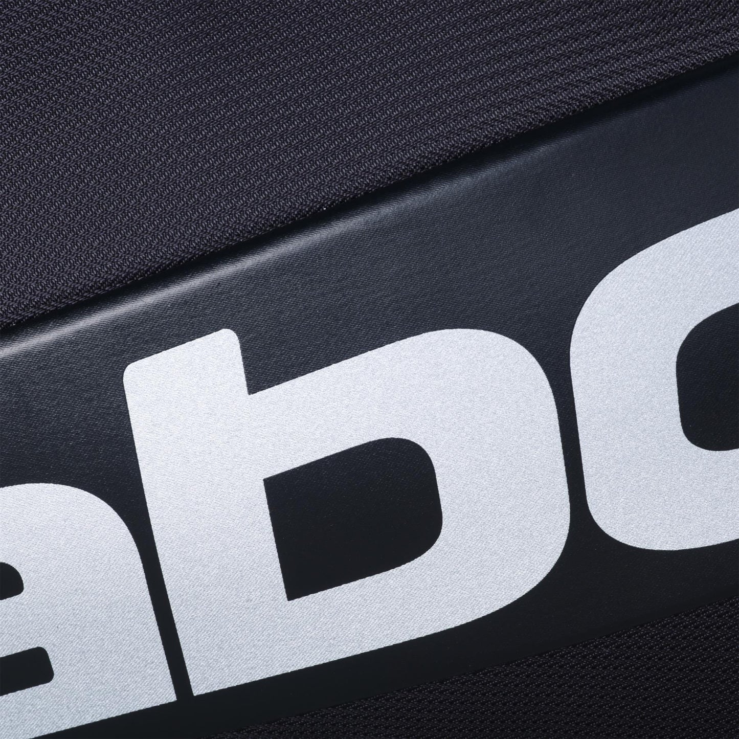 Close-up of black fabric with large white letters, from the Babolat RH Pro Padel Racket Bag (Black/Silver) by Babolat, featuring an insulated racket compartment and spacious storage for all your gear.
