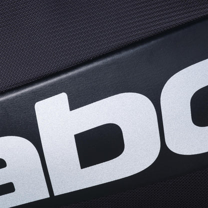 Close-up of black fabric with large white letters, from the Babolat RH Pro Padel Racket Bag (Black/Silver) by Babolat, featuring an insulated racket compartment and spacious storage for all your gear.
