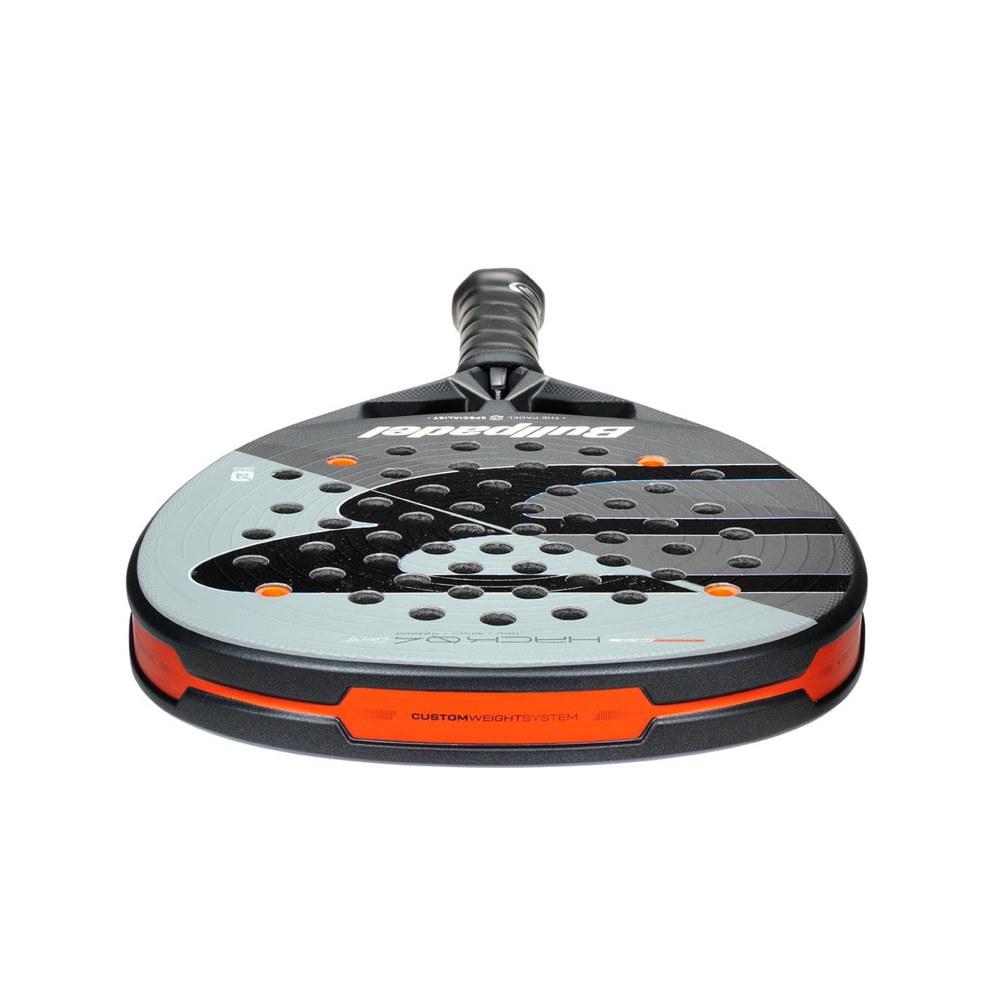 A close-up of the Bullpadel HACK 04 Comfort 2026 Padel Racket by Bullpadel, showing its black, gray, and orange design with multiple holes on the face and a textured grip handle for power and control.