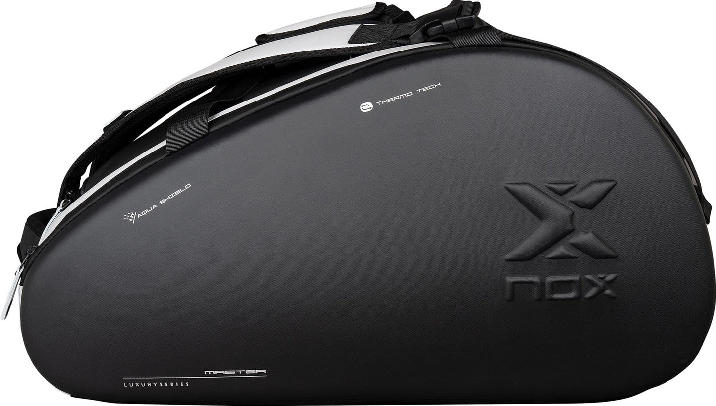 Carry your padel gear in style with the NOX Luxury Master Series Padel Racket Bag in Black/White, featuring a large embossed NOX logo, multiple zippers, and straps—designed for players who demand function and elegance.