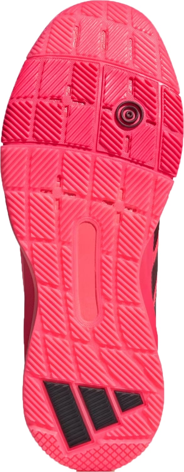The adidas Crazyquick LS Men's Padel Shoes in Solar Turbo/Core Black/Lucid Red feature a bright pink sole with textured, multi-directional grip, black accents, and a circular heel section for added flexibility and traction on the padel court.