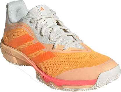 The adidas Crazyflight 7 Indoor Mens Padel Shoes feature a light orange and off-white design with white laces, orange side stripes, pink midsole accents, a textured sole, and LightstrikePro cushioning.