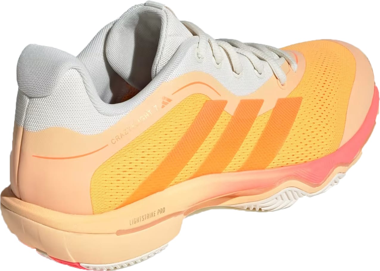 The adidas Crazyflight 7 Indoor Mens Padel Shoes in Lucid Tangerine/Lucid Orange/Off White feature white laces, mesh upper, three orange stripes, LightstrikePro cushioning, colorful accents, and "Lightstrike Pro" printed on the side.