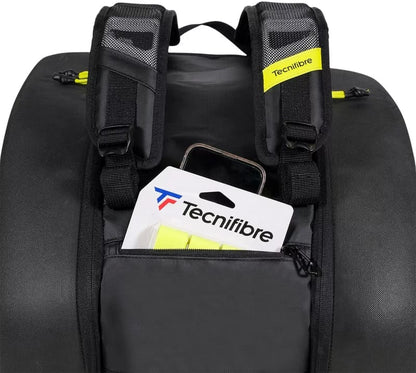 Close-up of the Tecnifibre Reform Padel Racket Bag in black/yellow with padded shoulder straps and a front pocket storing a Tecnifibre package and smartphone, offering reliable racket protection in a stylish, waterproof bag.