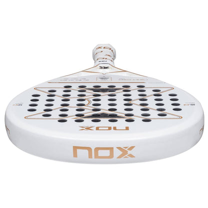 The NOX NextGen Pro Hybrid 12K NFA 2026 Padel Racket is white with gold and black accents, features a 12K Carbon Face with round holes, and "nox" branding near the handle—perfect for advanced players seeking peak performance.