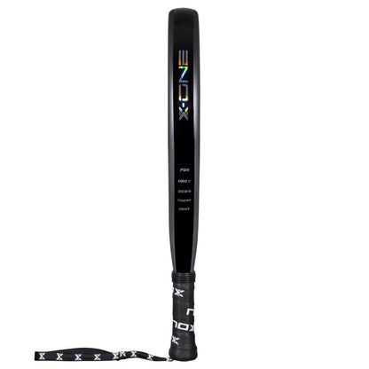 A black NOX X-One 2026 Padel Racket with a reflective "NOX" logo, white label beneath, and a wrapped handle with wrist strap featuring a repeating "X" pattern—ideal for beginners seeking control-focused performance.